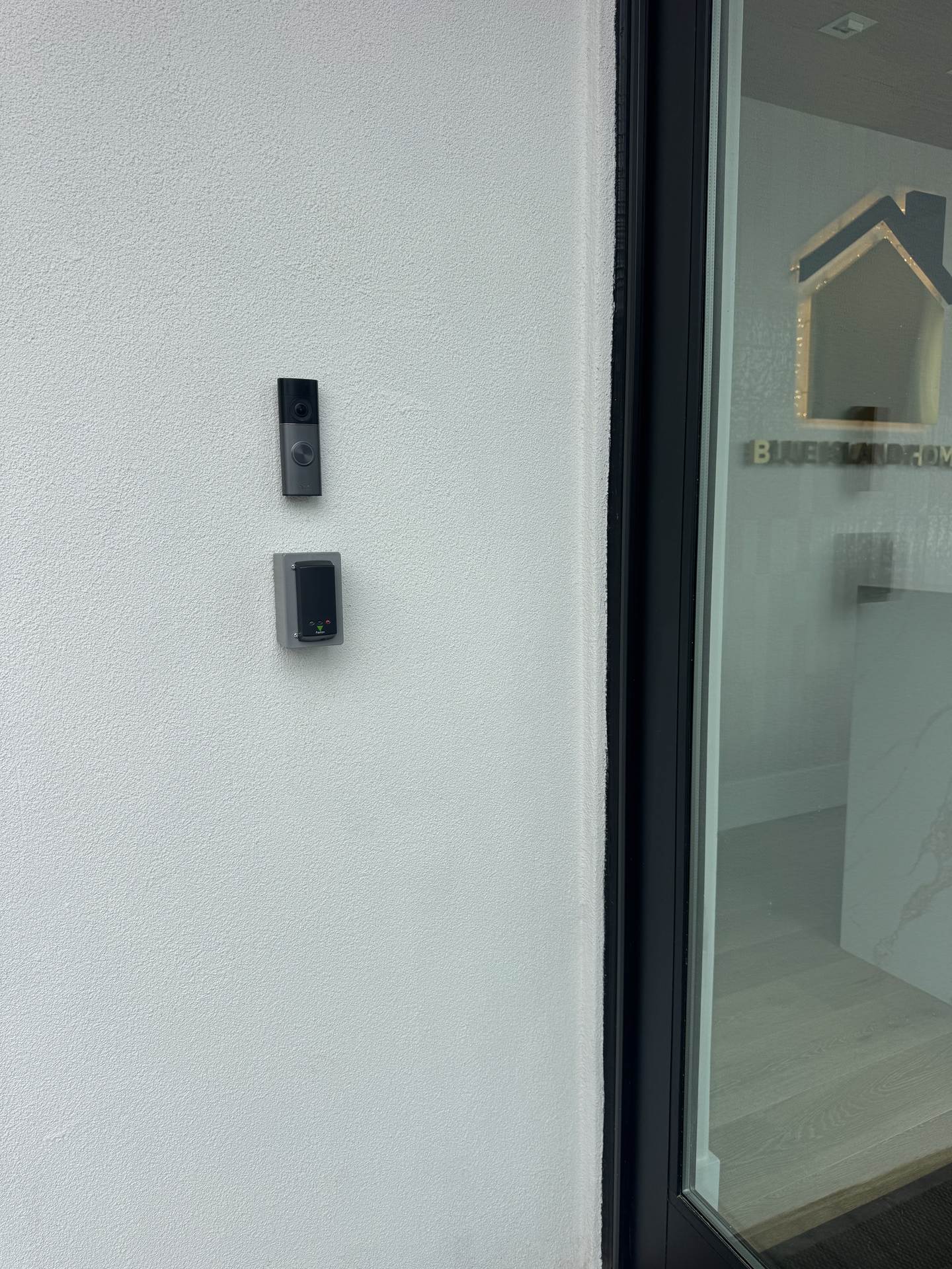 Video doorbell and access control card reader installed at a real estate office entrance in East Hills, NY